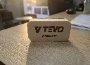 Side profile of V TEVO foam ceramic applicator pad placed on a wooden desk.